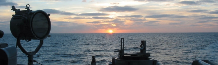 Navy ship bridge-wing at sunset